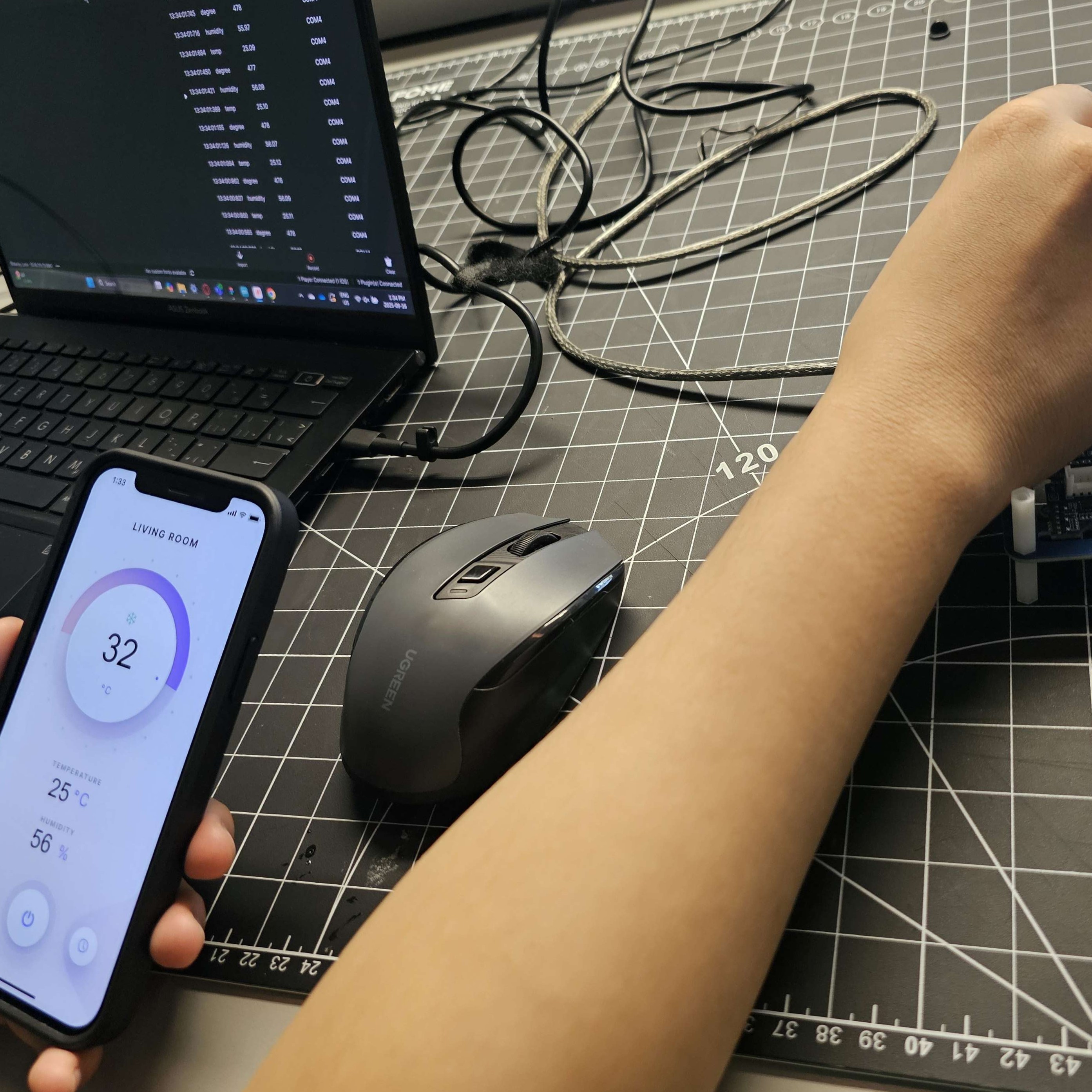 This is a bit of a rough screenshot, but to explain it, the top left shows the code on the computer, the bottom left is the temperature app where I connected my phone to using the ProtoPie app, and on the right where my hand is, is the Arduino kit board, which I played with to change the temperature apps data outcome, where the numbers changed showing the successful connection.