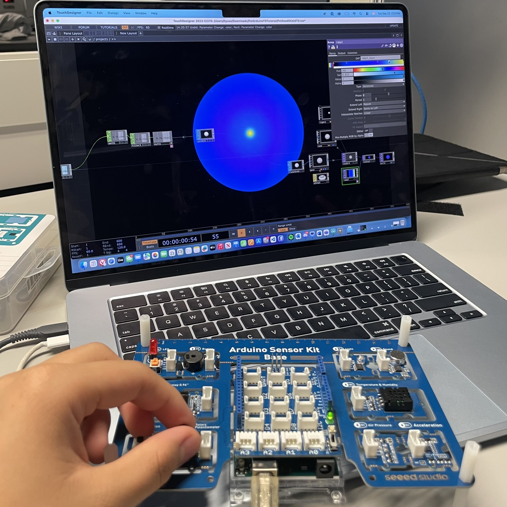 This is an image of the Touch Designer example being opened up, here we played a little bit with some of the settings to see if anything would change, and we were able to mess with the colors a bit. At the bottom is the Arduino sensor board where we played with the dial to see how the circle would react.